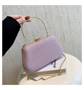 Pink glitter evening clutch bag with round gold handle and detachable chain strap detail