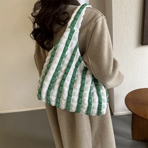 Bubble fabric striped tote bag with green and white pleated texture shown on model
