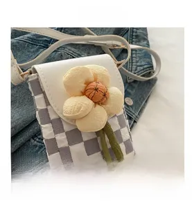 Detail of Korean purple checkered phone bag with large 3D fabric flower and green ribbons