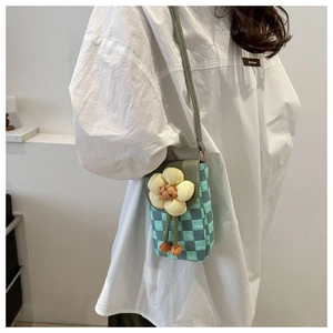 Detail of checkered crossbody phone bag with a large decorative fabric sunflower