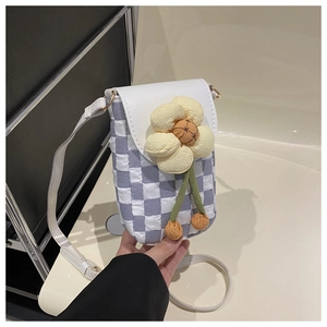 Detail of purple checkered crossbody phone bag with 3D yellow flower and white strap