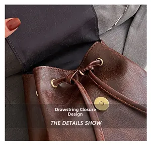Detail view of vintage brown leather backpack with drawstring and magnetic closure