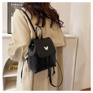 Black PU leather mini backpack featuring a silver metal butterfly on the flap with adjustable straps