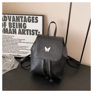 Detail of mini black faux leather backpack with white butterfly and drawstring closure