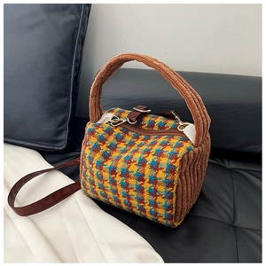 Detail of vintage houndstooth fabric and plush brown texture on small crossbody bag
