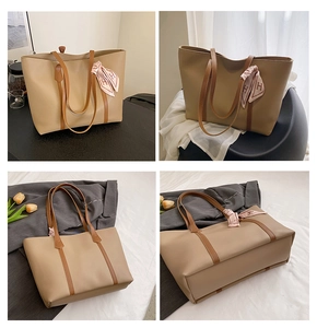 Detail view of khaki PU tote bag with silk scarf accent and long brown shoulder straps