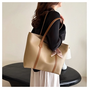 Minimalist light khaki tote bag featuring brown contrast straps and a pink silk scarf detail