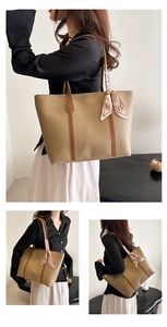 Detail view of khaki leather tote bag with brown straps and pink H-print silk scarf accessory