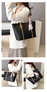 Detail view of large black leather tote bag with brown straps and pink H scarf decoration