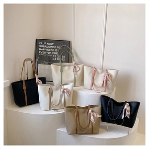 Fashionable large capacity leather tote bags with ribbon detail and sleek modern design