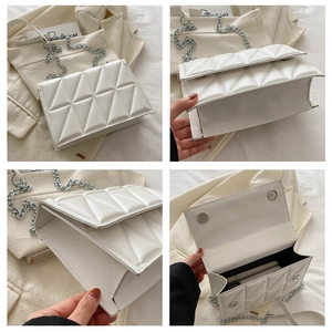 Detail view of white quilted square bag showing silver chain strap and internal storage space