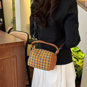 Retro multi-colored checkered crossbody bag with fuzzy brown handle and leather strap