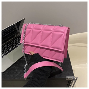 Detail of pink geometric quilted leather bag with silver chain and leather shoulder strap
