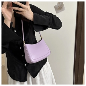 Detail view of light purple crescent shoulder bag with smooth leather and gold hardware