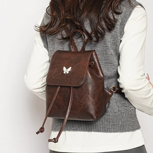 Minimalist dark brown leather backpack for women with white butterfly metal buckle decoration