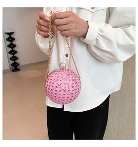 Detailed close-up of a pink spherical evening bag featuring a rhinestone textured surface