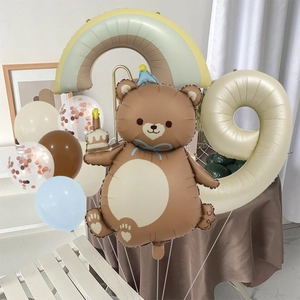 Birthday party balloon set featuring a cute brown bear, rainbow, and cream number 9 balloon