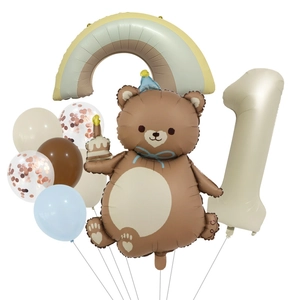 Detail of first birthday balloon set with brown bear, rainbow, and cream number one