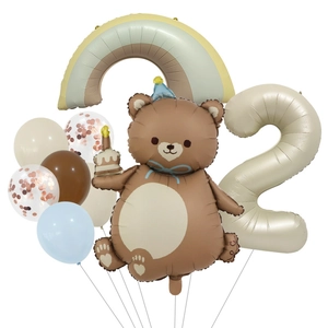 Detail of 2nd birthday set with cartoon bear, rainbow foil, and cream number 2 balloon