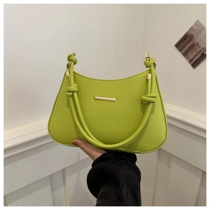 Vintage lime green shoulder bag with woven handle and gold hardware in modern style
