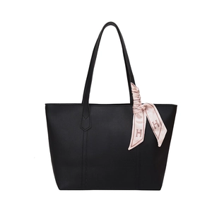 Minimalist black tote bag with long straps and a decorative pink silk scarf accent