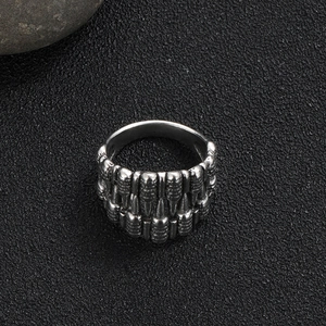 Close-up of vintage punk ring featuring double row bullet shell relief in antique silver