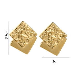 Detail of vintage double-layered square earrings with hammered texture and matte gold finish