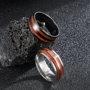 Vintage stainless steel men's rings featuring wood grain inlay on black volcanic rock