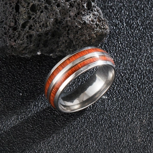 Detail of vintage men's steel ring with double inlaid reddish-brown wood grain textures