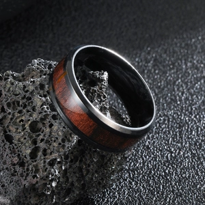Men's black stainless steel ring with wood inlay on volcanic rock base, 45-degree angle