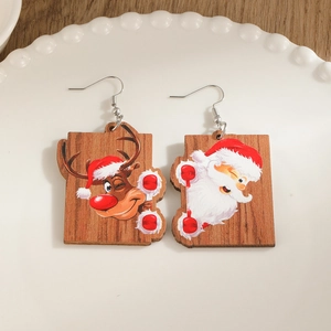 Creative Christmas wooden puzzle earrings featuring Santa Claus and reindeer on a ceramic plate