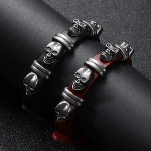 Set of two punk leather skull bracelets in black and dark red with silver metal details