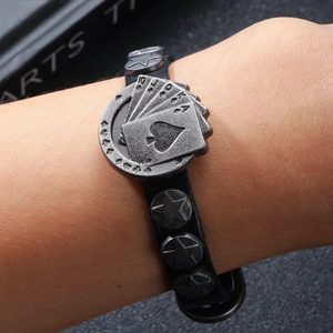 Punk leather bracelet with vintage silver poker cards and star studs on hand