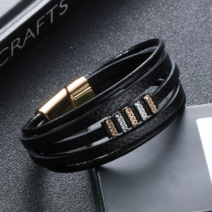 Detail of multi-layer black leather bracelet with silver rings and magnetic clasp