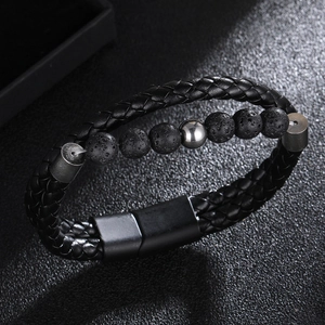 Macro shot of men's leather braided bracelet with lava stone beads and magnetic metal clasp