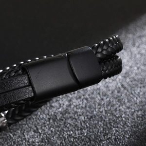 Close-up of black braided leather multi-layer bracelet with matte metal magnetic clasp