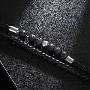 Men's black braided leather bracelet featuring natural lava stone and silver metal bead
