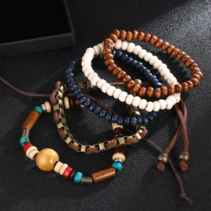 Detail of bohemian multilayered beaded bracelets with wood beads and leather cords