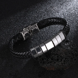 Men's braided black leather bracelet with stainless steel cylinders on volcanic stone