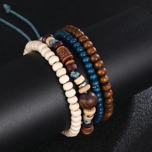 4-piece vintage wooden bead bracelet set with bohemian patterns on a black display