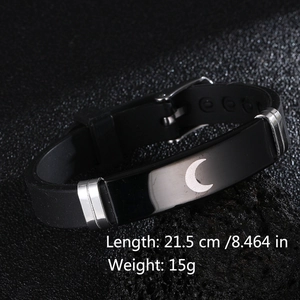 Detail view of black silicone couple bracelet with silver moon engraving and buckle