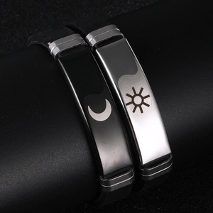 Close-up of sun and moon silicone couple bracelets with polished stainless steel plates