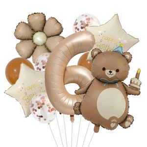 Detail of bear and number 6 foil balloons for birthday party decor in cream and rose gold