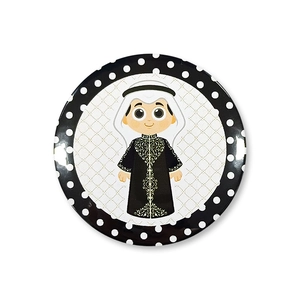 Detail of round tinplate badge featuring a cartoon boy in Middle Eastern traditional dress