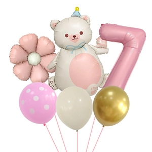 Detail of bear shaped balloon with pink daisy flower and number seven for party decoration