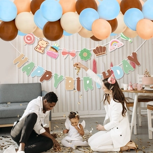 Teddy bear party kit with balloon arch and Happy Birthday banner in modern living room