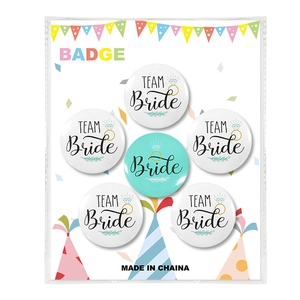 Macro view of 6pcs Bride and Team Bride tinplate badges on festive decorative card