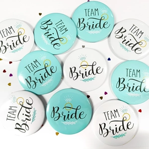 Group of mint and white Team Bride badges with diamond icons on confetti background