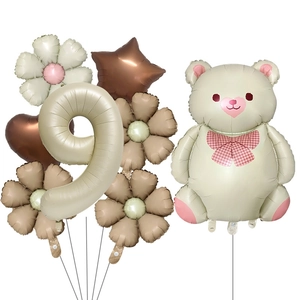 Detail of bear foil balloon set with number 9 and daisy shapes for party decor