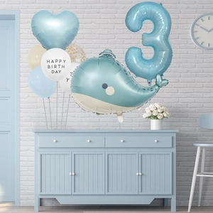 Detail of blue whale and number 3 foil balloons for ocean themed 3rd birthday party decor
